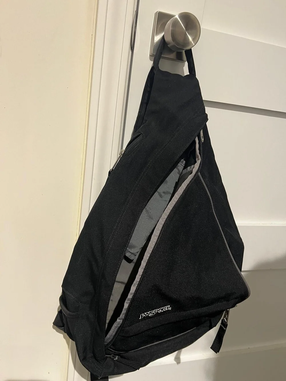 Jansport Black Sling Backpack with Front Zip Pocket